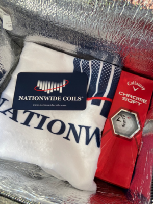 Nationwide Coils promotional items including a branded towel and Callaway golf balls.